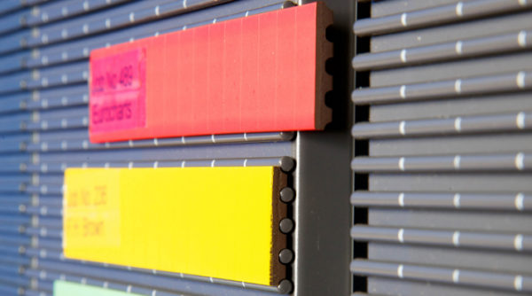 Profiled Magnetic Text Plates lock onto the ribbed panel surface